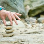 person piling brown stones